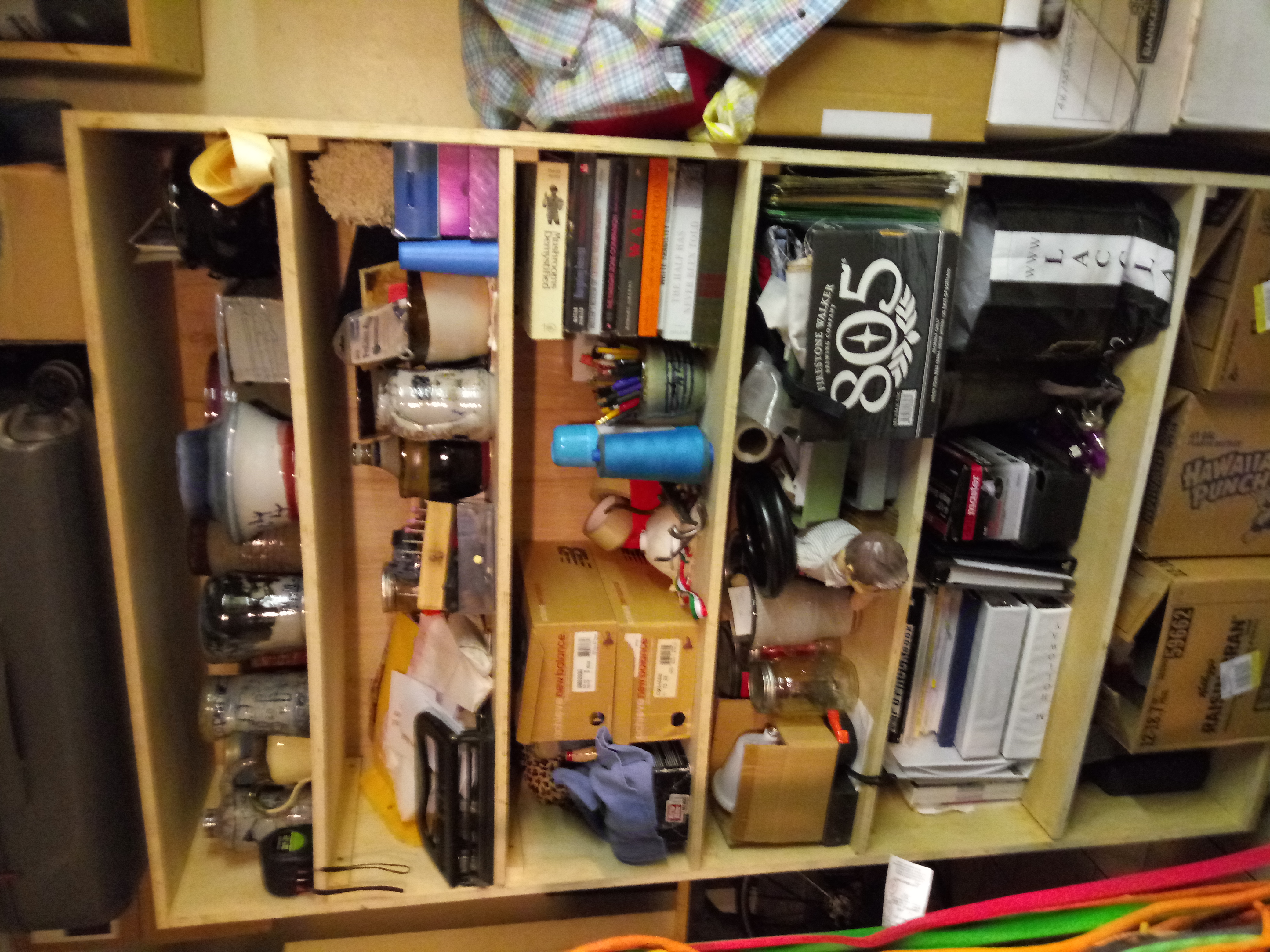 Shelf of miscellaneous sewing, jewelry, and other raw materials and tools